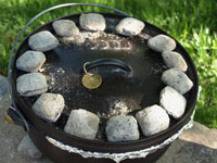 Ringed charcoal placement on a Dutch oven